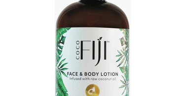 Organic Fiji Pineapple Coconut Moisturizing Lotion bottle surrounded by tropical pineapples and coconuts