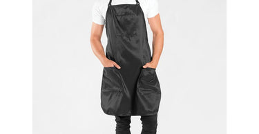 Premier Barber Apron in Black by Betty Dain shown on a mannequin, demonstrating its professional fit and water-resistant fabric.