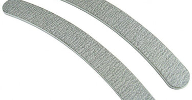 A professional holding a Premium Zebra Cushion Nail File by DHS Products, showcasing the banana shape and cushion core for comfort and durability.