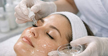 Aesthetician gently applying a PHA product to a client's face during a sensitive skin consultation before a chemical peel