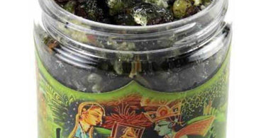 Prabhuji Resin Incense Lakshmi Money and Prosperity 2.4 oz Jar on a wooden table with smoke rising for spa aromatherapy.