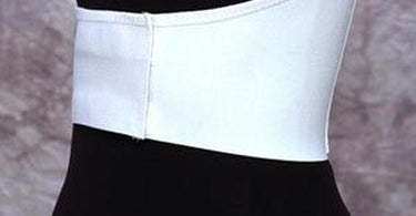Rib Belt Female with Dart shown on a massage table with spa linens, demonstrating its professional use in a therapeutic setting.