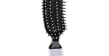 Scalpmaster Banana 7 Row Brush shown on a clean surface, highlighting its curved yellow handle and dense bristles.