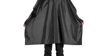 A professional stylist drapes a Scalpmaster Nylon Styling Cape with a black velcro closure on a client, ensuring full protection during a salon haircut service.
