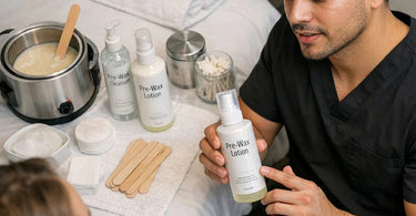 Selection of pre-wax cleansers and lotions for stripless wax application on a spa treatment table with cotton and spatulas.