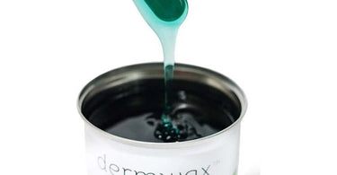 Esthetician applying soft wax on a client's leg in a professional spa setting