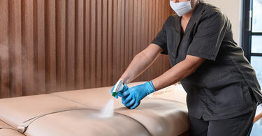Spa technician disinfecting a vinyl spa bed with Lucas Products