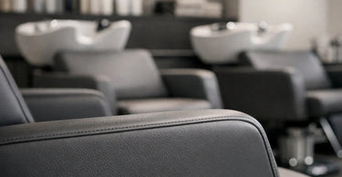A modern, white salon chair with anti-microbial finish in a bright, clean studio, representing the new standard in spa hygiene and infection control.