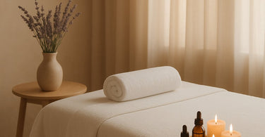 A spa professional smiling while holding a tablet, symbolizing warm and modern client communication in a relaxing wellness setting.