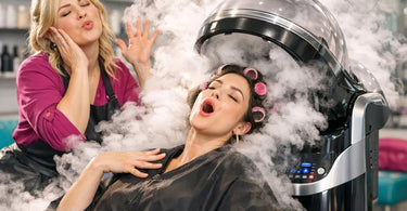 A professional hair steamer in use at a modern salon, showing a client comfortably seated with the steamer hood over their hair during a deep conditioning treatment.