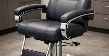 A close-up view of a professional salon chair, highlighting the plush, adjustable armrest designed for client comfort and ergonomic support during long beauty services.