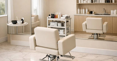 A beautifully styled spa menu book lying open next to a clean wax pot, tweezers, and bottles of professional oil on a linen towel