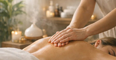 A spa professional performing a therapeutic hand massage on a client in a serene, calm treatment room