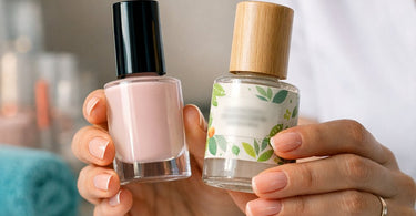 A professional nail technician holds a bottle of premium gel nail polish, symbolizing the shift towards non-toxic and certified nail products in the salon.