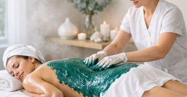 A relaxing spa treatment showing a client comfortably wrapped in a marine algae body wrap, with warm towels and a serene atmosphere.