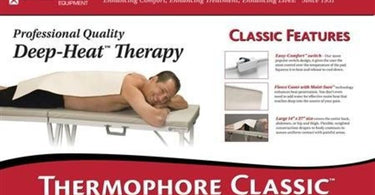 A professional-grade Thermophore Moist Heat Pack, draped over a massage table, ready for spa and salon use