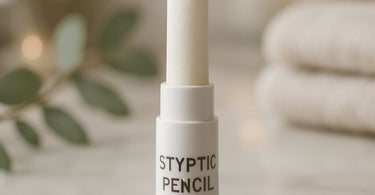 Close-up of a professional styptic pencil on a spa towel with waxing supplies