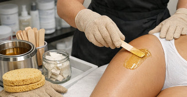 Eco-friendly biodegradable sponges and protective gloves for professional spa and salon use displayed on a bamboo surface
