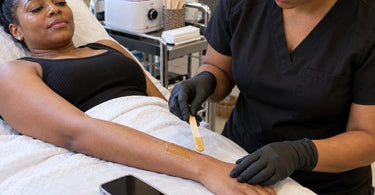 Client smartphone placed in an inconvenient location near professional spa treatment equipment, highlighting treatment room organization and phone safety