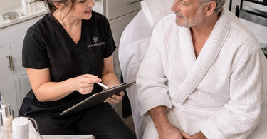 A welcoming spa reception area with a tablet displaying a modern digital intake form, symbolizing a personalized client onboarding experience.