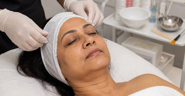 Woman receiving a spa facial treatment with her hair carefully protected by a towel to prevent damage from products and steam.