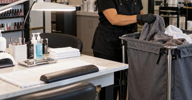 Laundry cart filled with used spa and salon towels illustrating cross-contamination risks and professional linen handling hygiene
