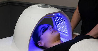 Professional LED light therapy device in use at a modern spa treatment room