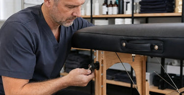 A modern massage table in a professional spa room, highlighting the tools for a consistent hardware check