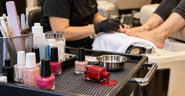 Nail polish bottles at a professional pedicure station illustrating common tipping hazards and practical ways to prevent polish spills
