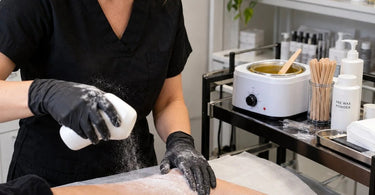 Professional pre-wax powder used for skin preparation before salon waxing treatments, highlighting controlled powder application and a clean esthetician workstation