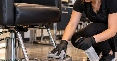 Professional salon styling chair footrest showing the area where shoe marks, hair clippings, and everyday debris accumulate during hair salon services
