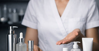 A spa professional writing in a service menu notebook with professional beauty products in the background