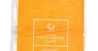 XL Processing Caps by Color Trak - 100 Pack display box on a salon counter with a hair color brush and bowl in the background.
