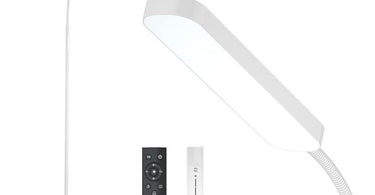 Sleek matte white LED floor lamp with adjustable gooseneck positioned next to a modern spa treatment chair