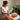 An esthetician in a serene spa setting using a magnifying lamp to examine a client's skin