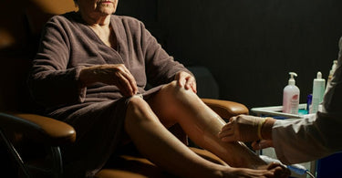 Mature woman receiving a professional waxing treatment in a spa setting