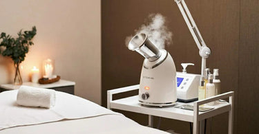 Esthetician using a facial steamer on a client in a spa setting