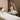 Esthetician using a facial steamer on a client in a spa setting