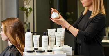 Professional hair care products and tools arranged neatly on a salon counter