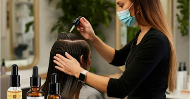 Salon professional applying hair growth treatment to a client's scalp