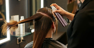 Professional hairstylist providing hair care treatment to a client in a salon