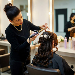 Stylist creating an elegant updo for a client in a salon