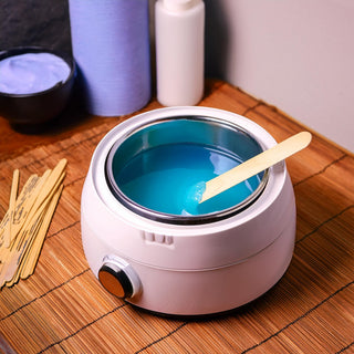 Wax warmer in a spa room for waxing services. blue wax in the wax pot