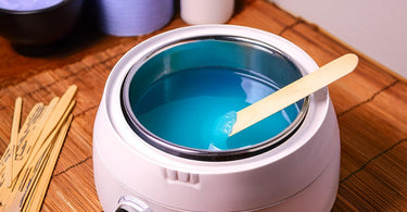 Wax warmer in a spa room for waxing services. blue wax in the wax pot