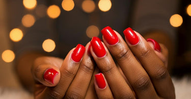 A close-up of a person's hands receiving a professional manicure, highlighting the care and attention given to nail and hand health.