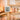 A digital hygrometer displaying temperature and humidity levels in a serene salt therapy room with salt bricks and spa products.