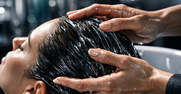 Close-up of healthy, shiny hair being treated with a professional protein complex serum, illustrating the skinification of hair trend