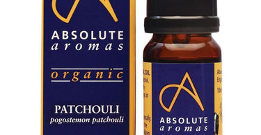 Absolute Aromas Organic Patchouli Essential Oil bottle shown alongside dried patchouli leaves