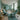 A spacious and modern spa treatment room featuring an adjustable-height massage table and wide clear pathways for easy accessibility