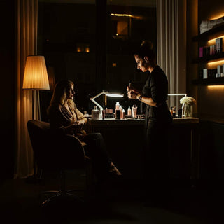 A spa professional preparing for an after-hours beauty service in a tranquil, softly lit setting